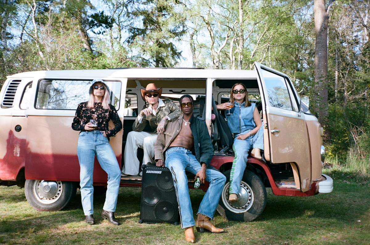 people around a backyard camp with a soundboks