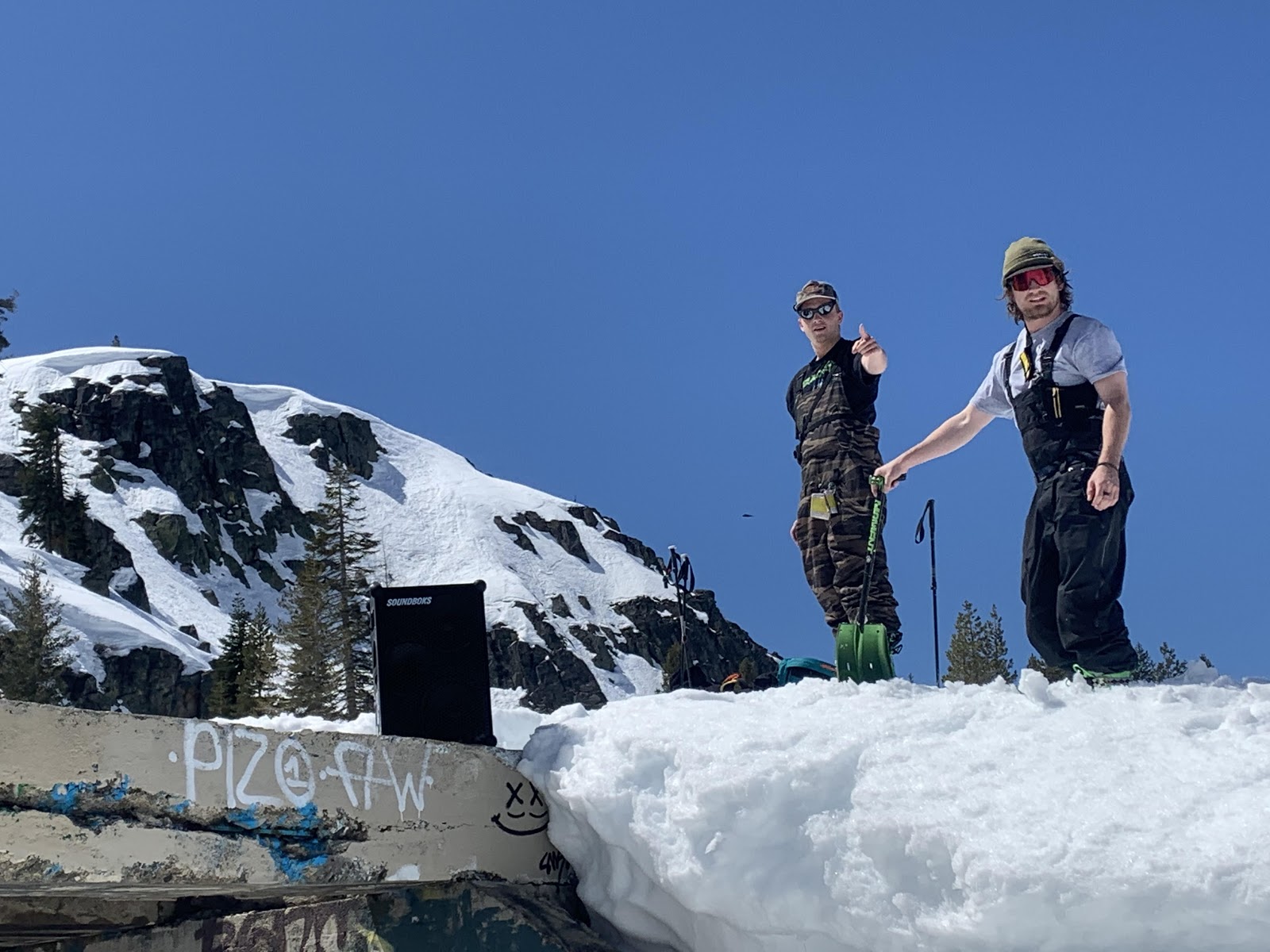 Two guys skiing with a SOUNDBOKS