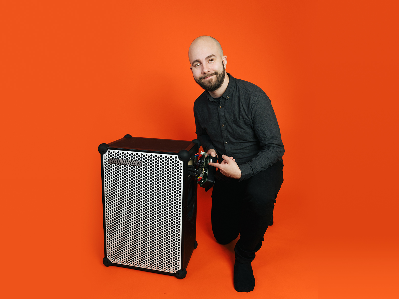 David, SOUNDBOKS developer in front of an orange background