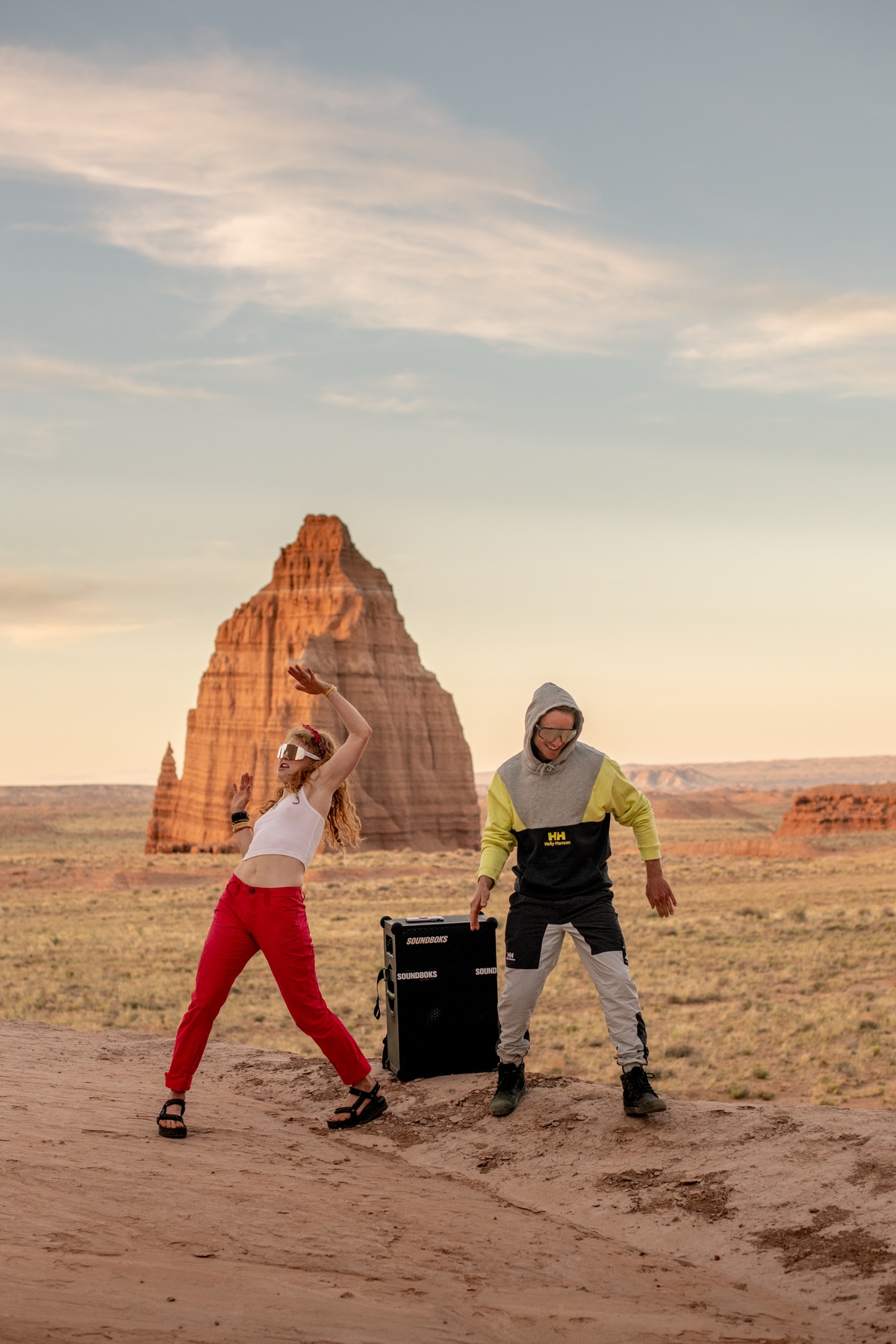 girl and guy dancing to a SOUNDBOKS in the desert