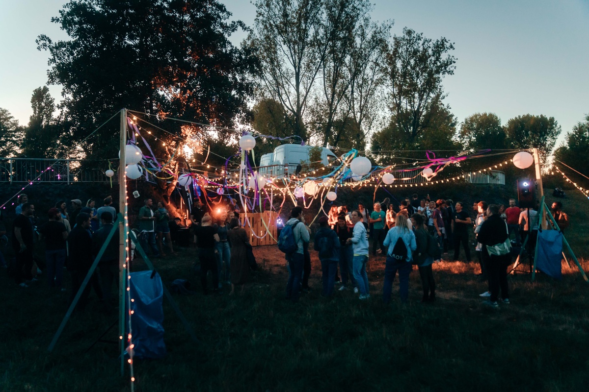 group of people partying outside with a SOUNDBOKS speaker