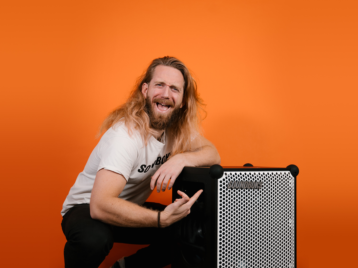 Kalle, Digital Project Lead at SOUNDBOKS in front of an Orange Background.