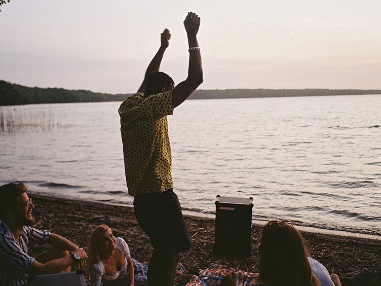 People listening to music from a SOUNDBOKS by the ocean