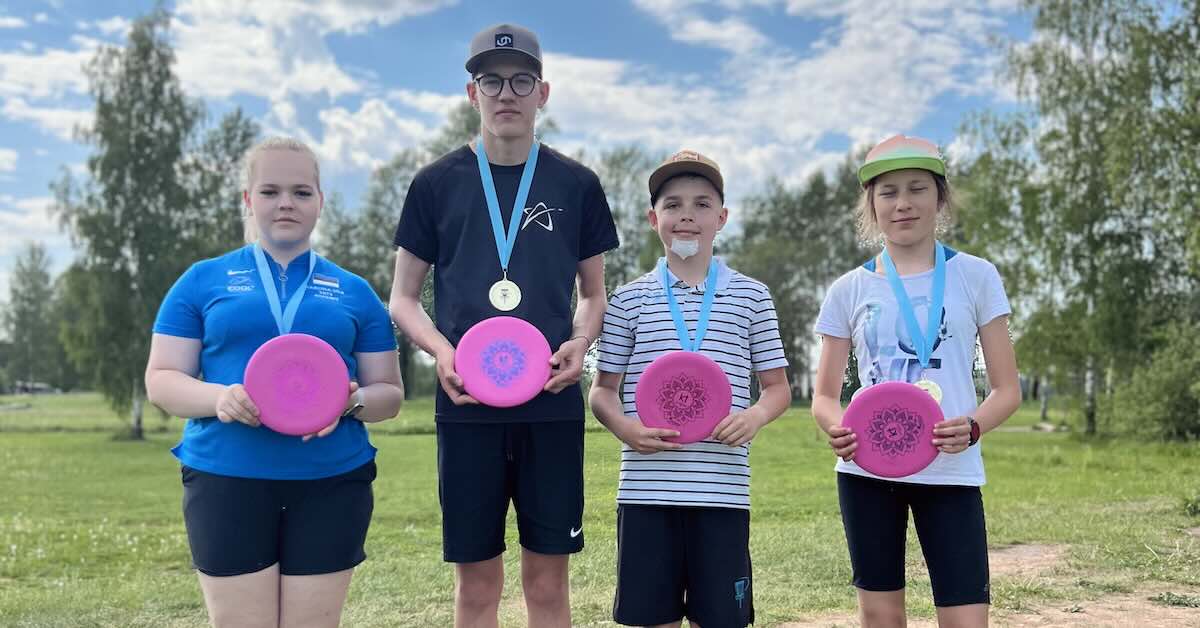 Young people posing with medals and discs