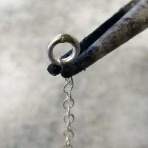 Soldering the jump ring to the chain using a third hand