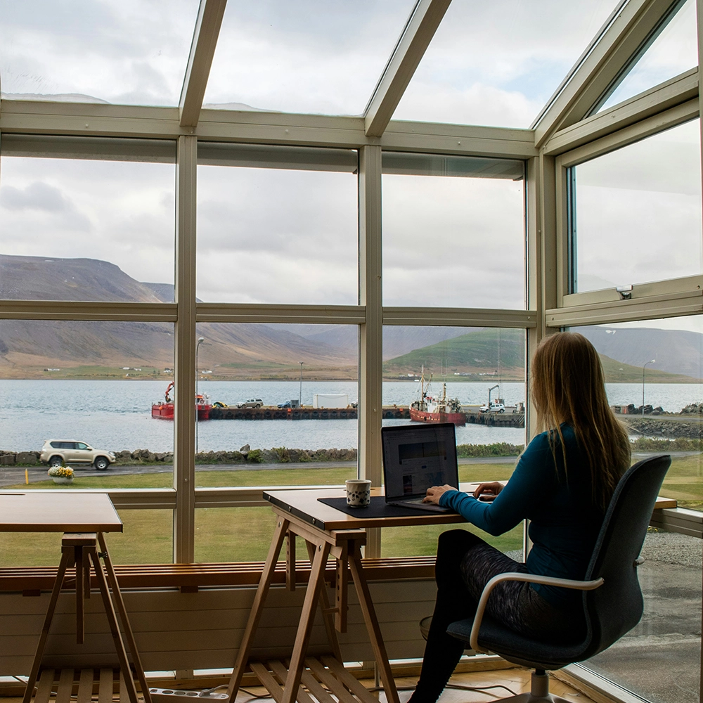 Woman working remotely at a cafe while traveling.