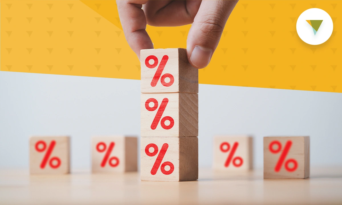 Hand stacking blocks with percent signs on them.