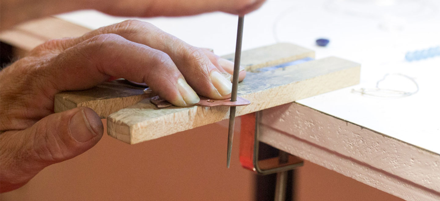 This overview details an essential jewelry studio tool and its best use: the bench pin and sawing. Learning how to use it and tips for sawing.