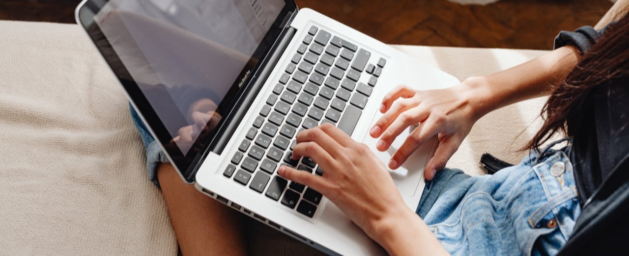 Person typing on a password secured laptop.
