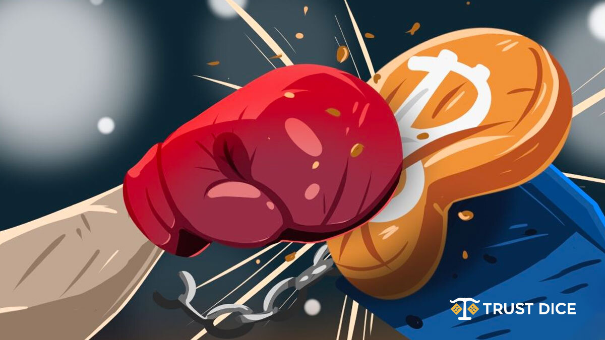 Bitcoin punched by hand with boxing gloves