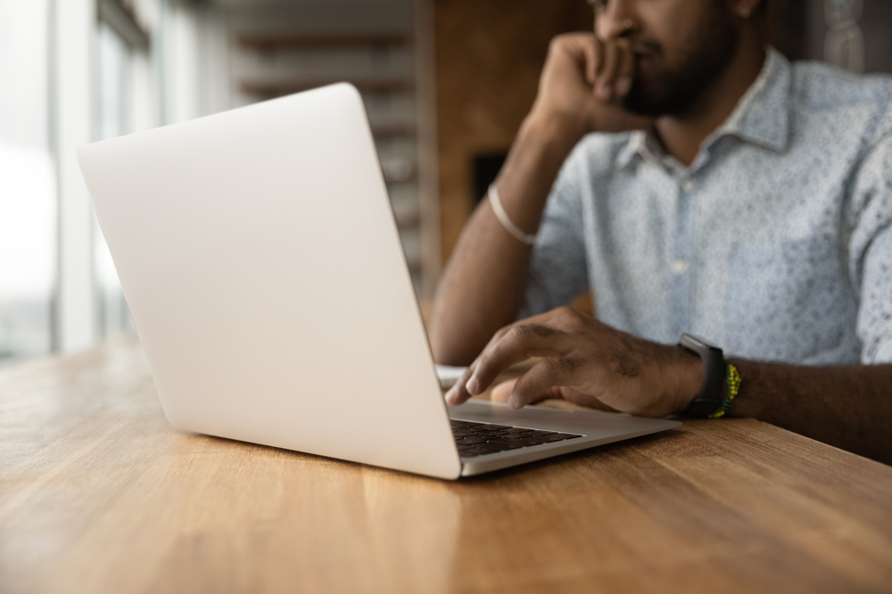 Man typing on a laptop