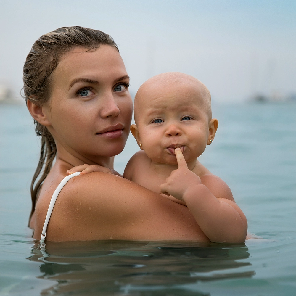 Baby and mom in ocean.webp