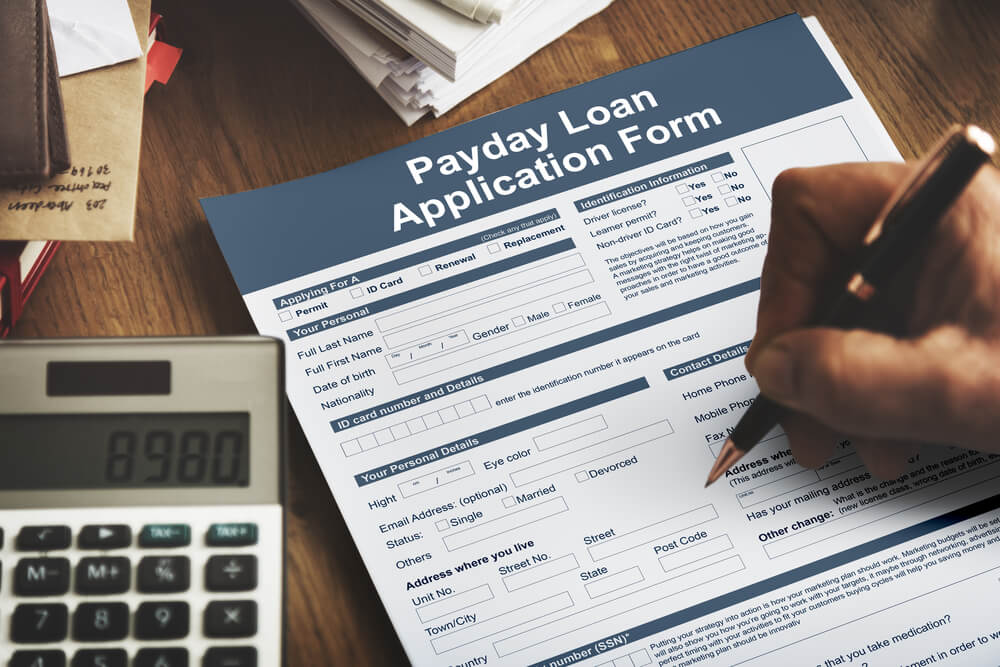 person filling out fast payday loan application