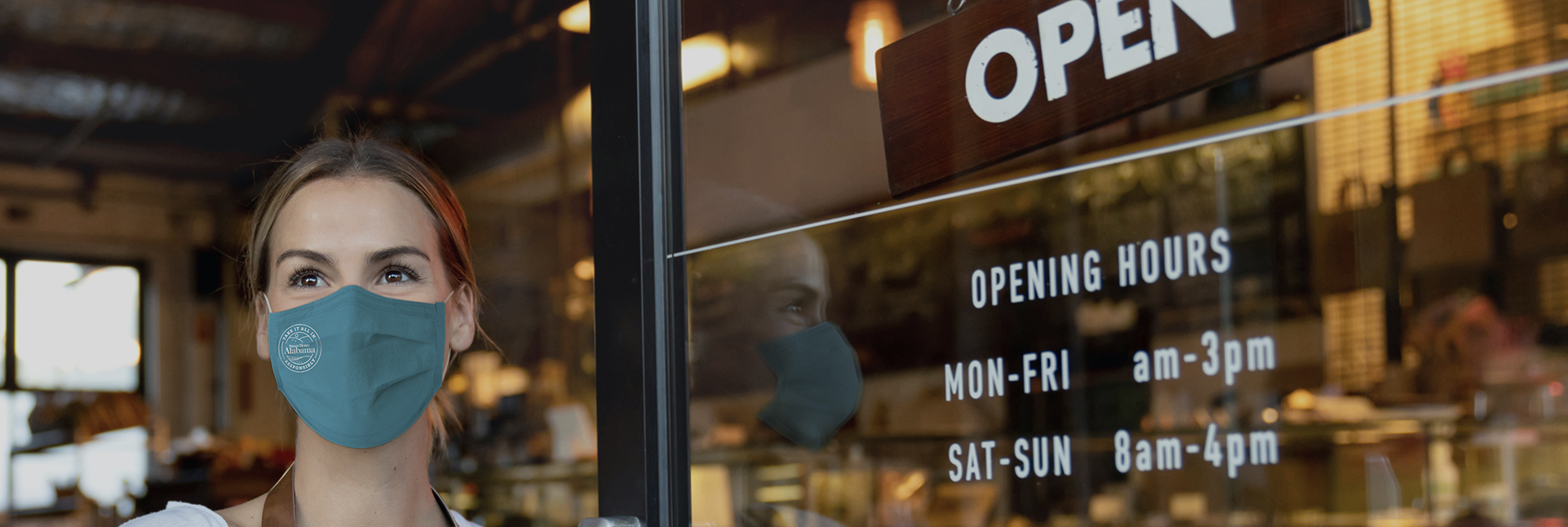 Person wearing mask outside of a cafe