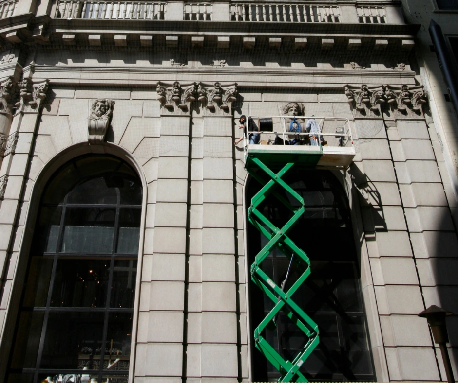 outdoor scissor lift repairing side of building