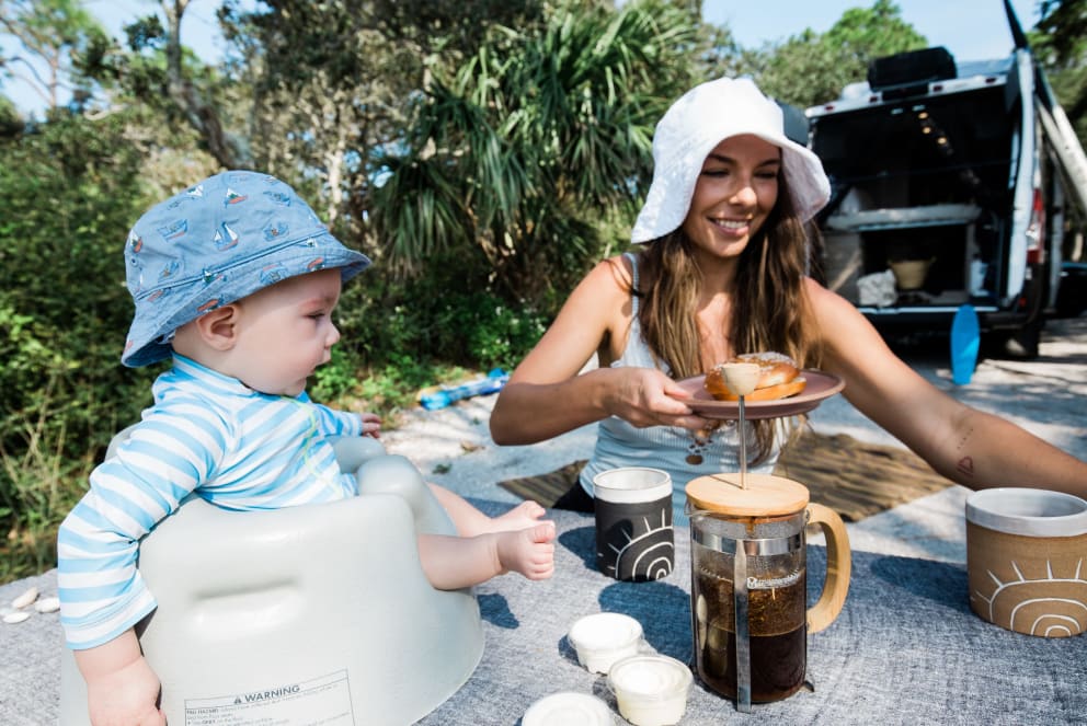 woman and son eating at florida campground outside of winnebago solis rv