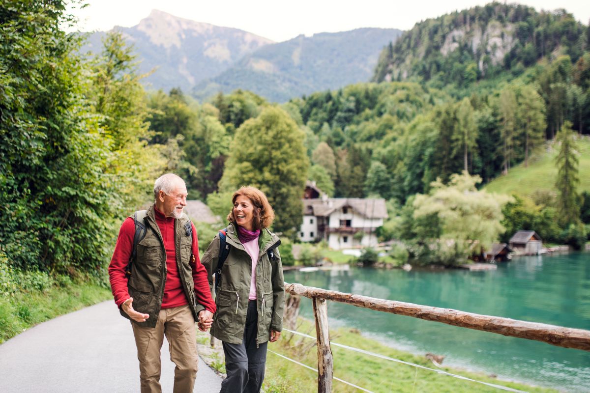 Couple enjoying a hike, traveling with Medicare