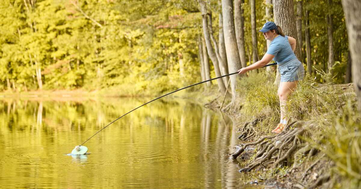 A woman using a telescopic pole to retrieve a disc from a creek. Right: A telescopic retrieval stick with multidirectional suction cup head
