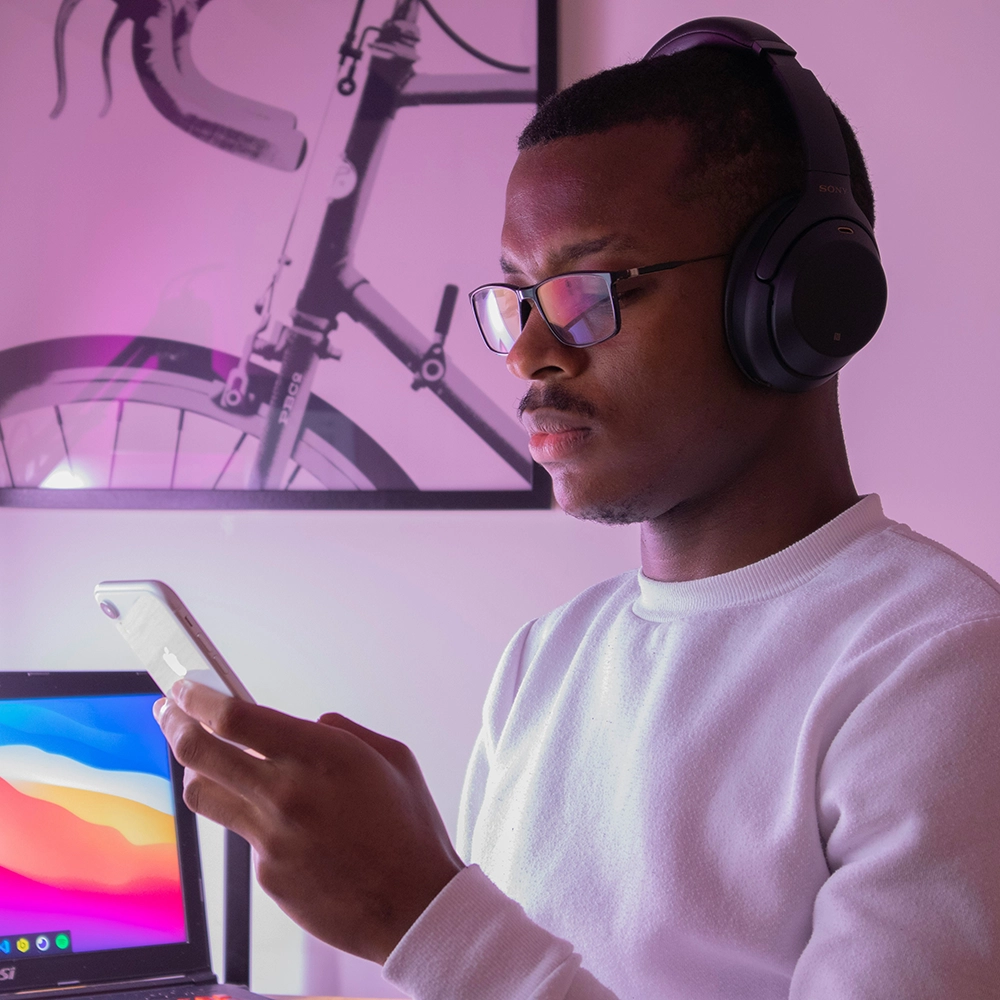 A man wearing headphones on his phone.webp