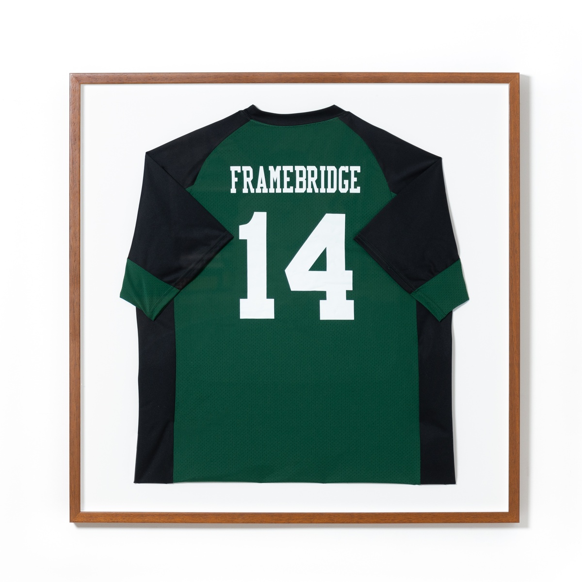 green soccer jersey in wood frame