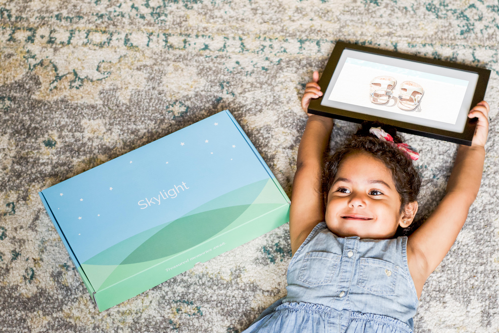 Child holding digital photo frame