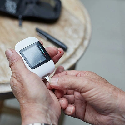 Man testing blood sugar.