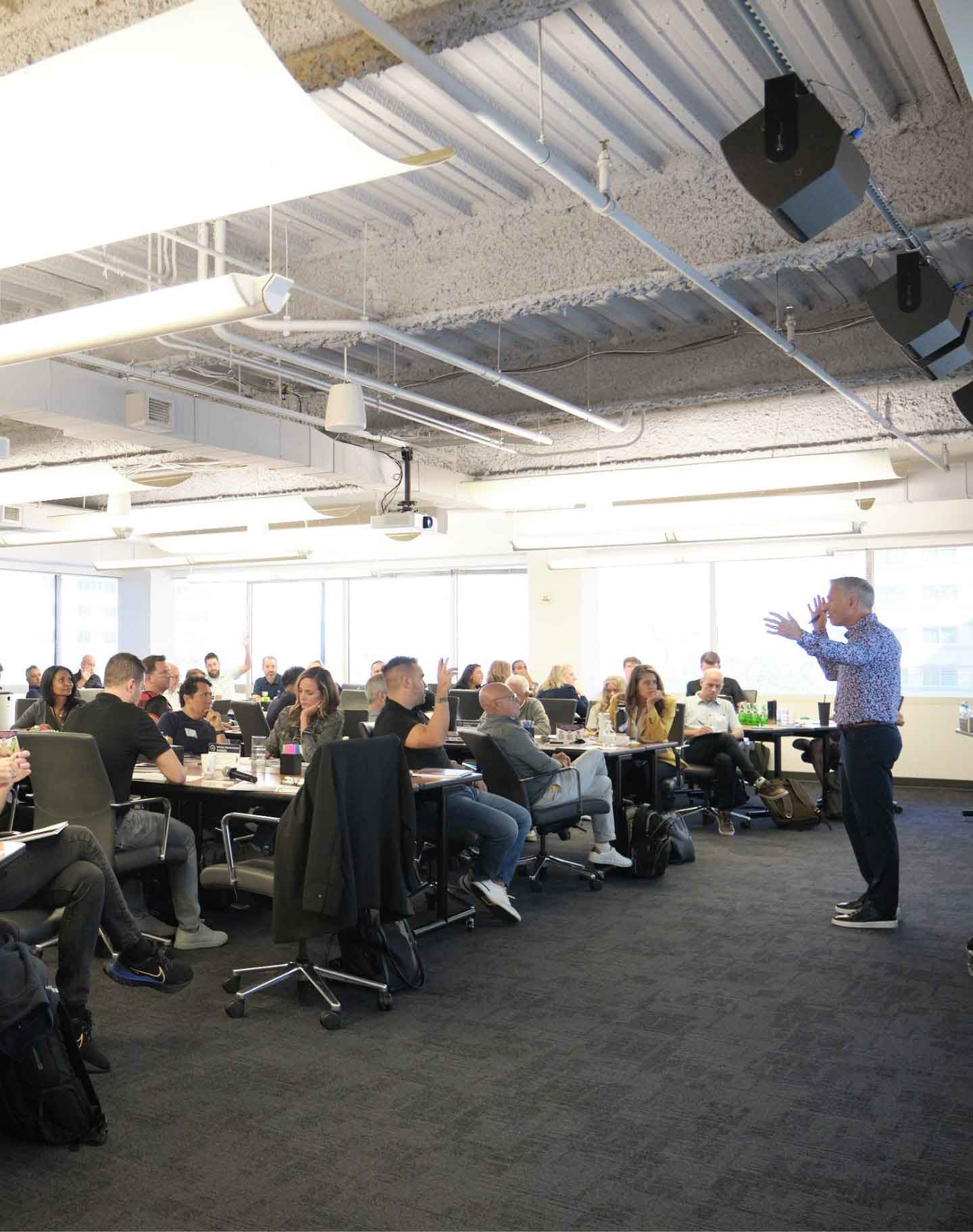 Workshop room full of entrepreneurs with a coach at the front at Strategic Coach Chicago Location