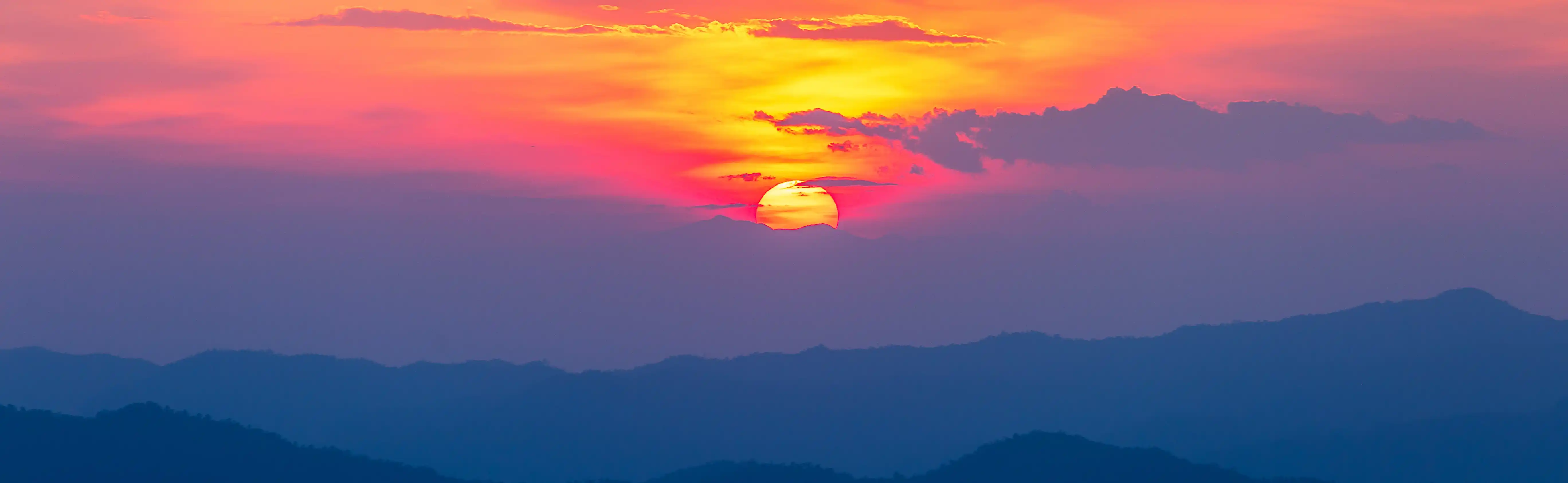 Vibrant sunset over mountains symbolizing sustainable business future