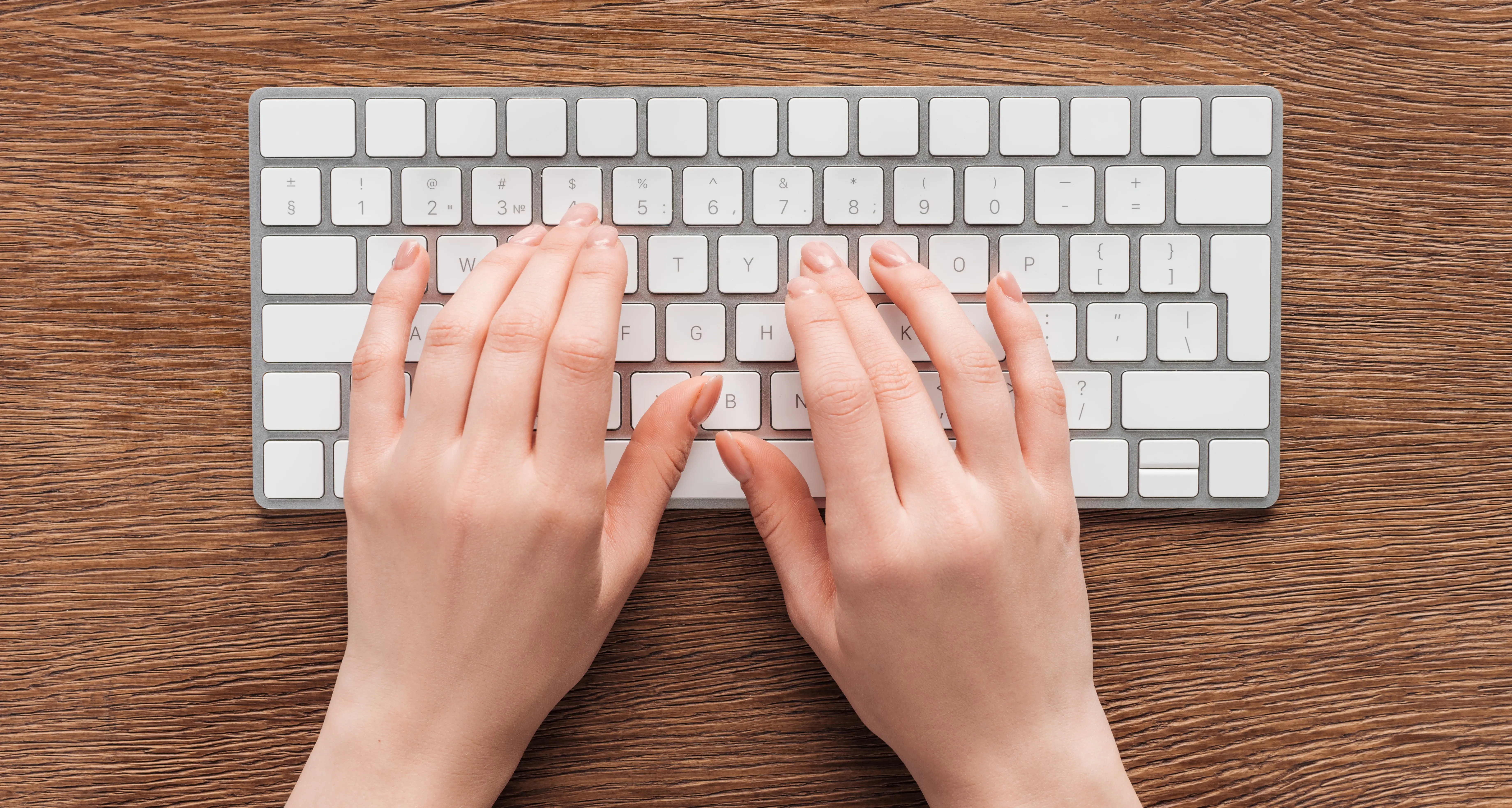 Close up of hands typing on ergonomic keyboard for remote work