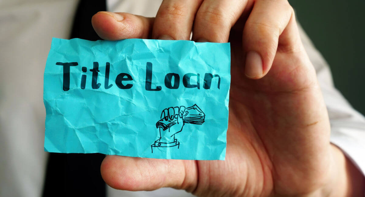 A picture of a person holding up a post-it note related to same-day title loans.