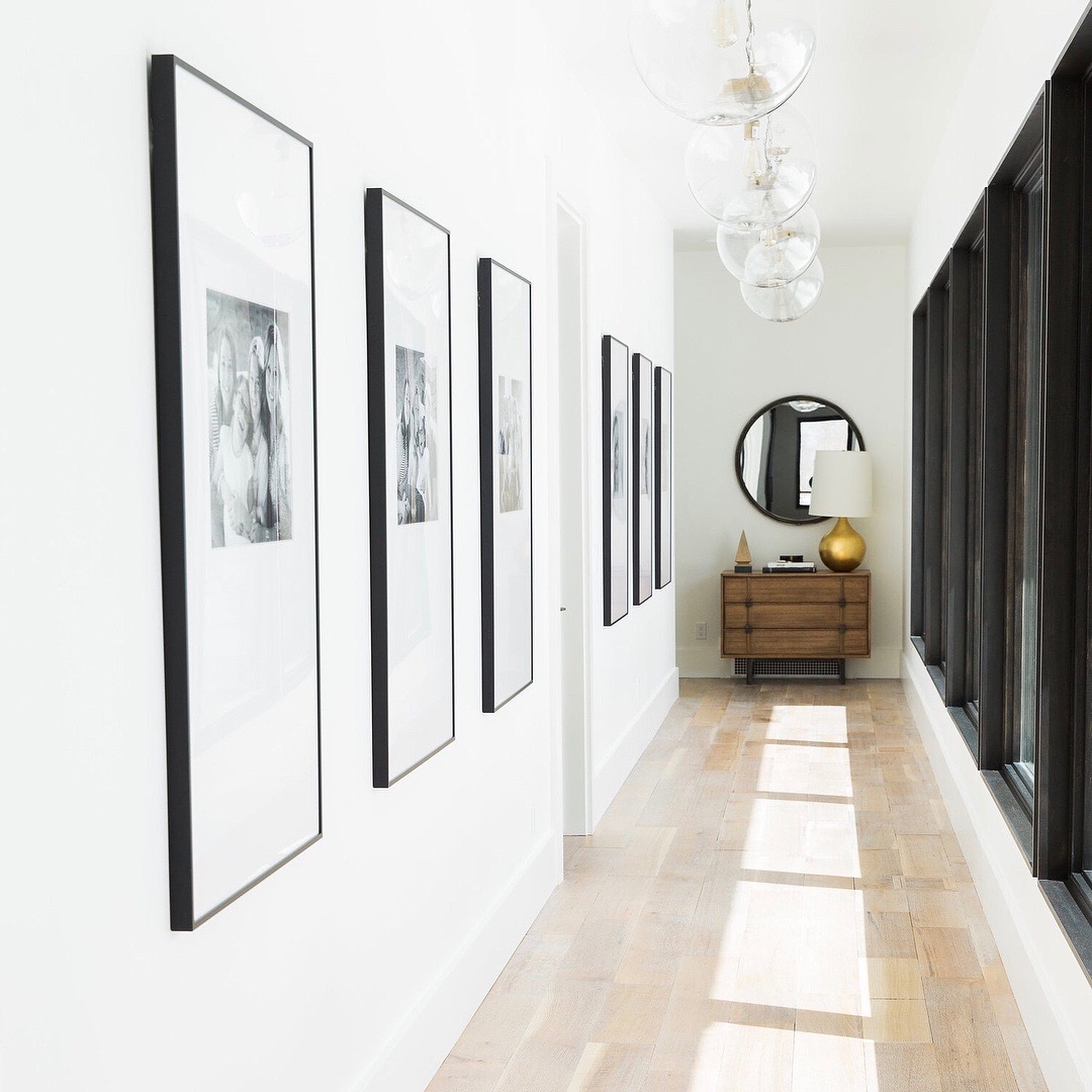 hallway with windows and six black frames