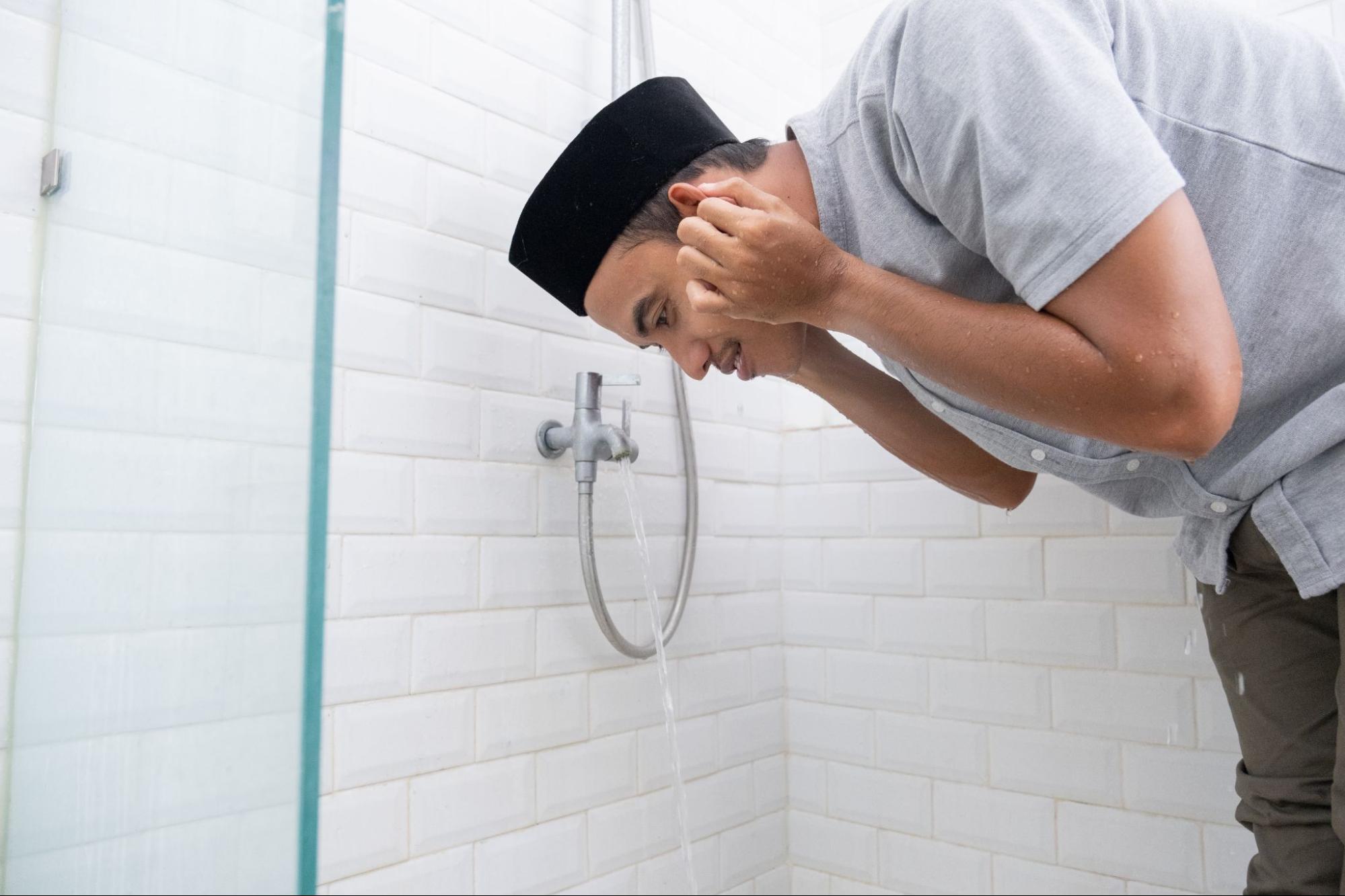 Man cleaning his ears in the shower