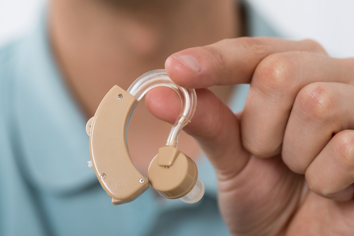 Person holding hearing aid