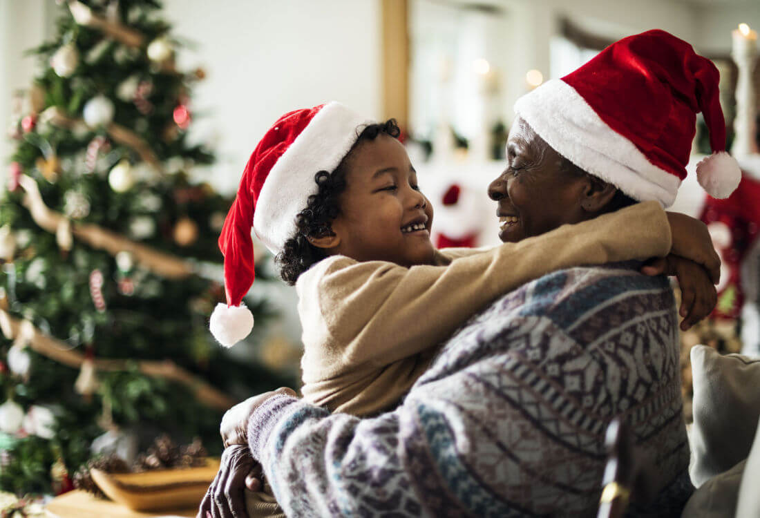 A black grandfather hugs his grandaughter after receiving holiday cash through an installment loan.