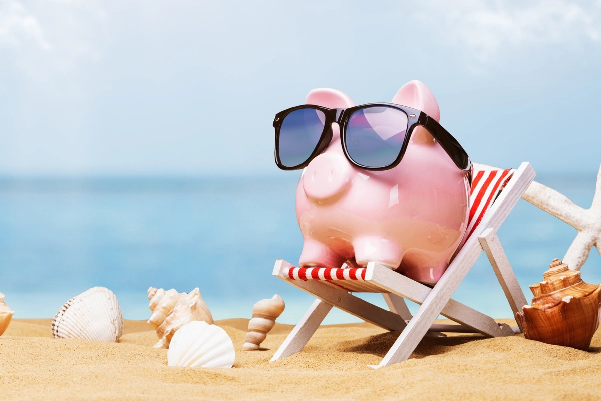 how to save money on Medicare premiums: piggy bank on beach
