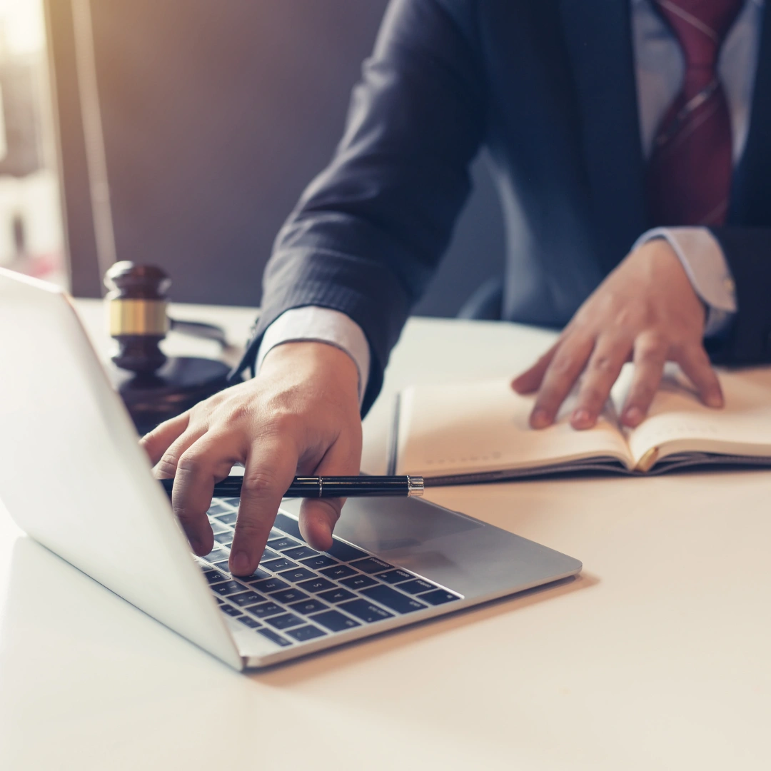 A law firm employee working on laptop.