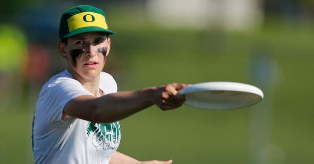 Close up of a woman throwing a Frisbee during an ultimate game
