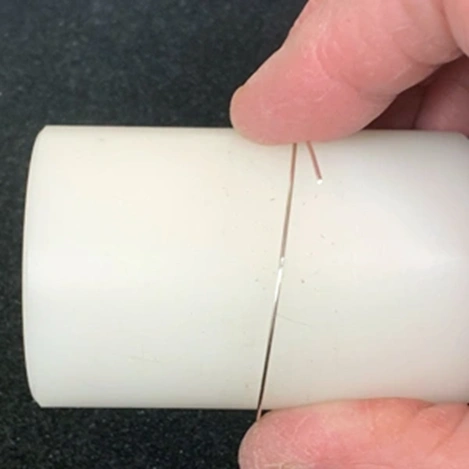 wrapping wire around a plastic cylinder