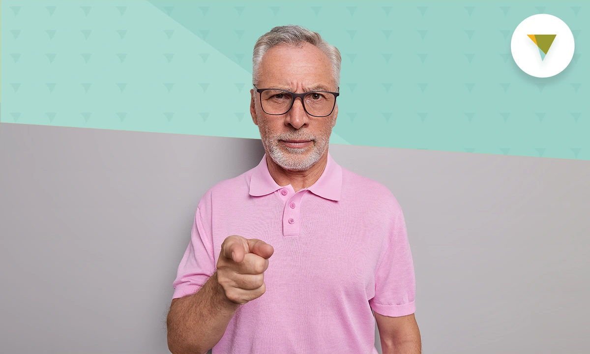 Senior man pointing at camera,