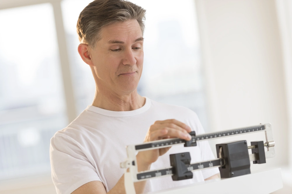 Man weighing himself