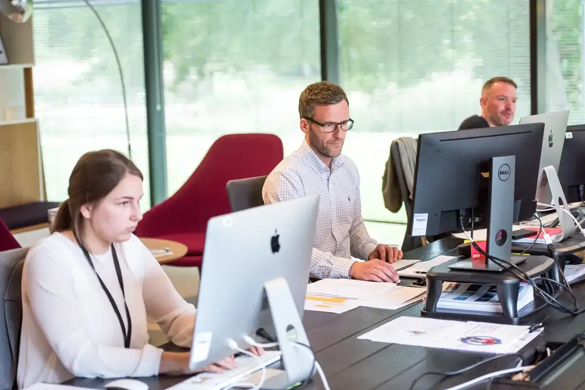 Employees working together in a room.