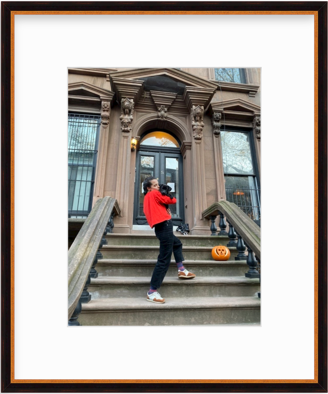 photo of woman with dog on stairs to brownstone in gold and black frame