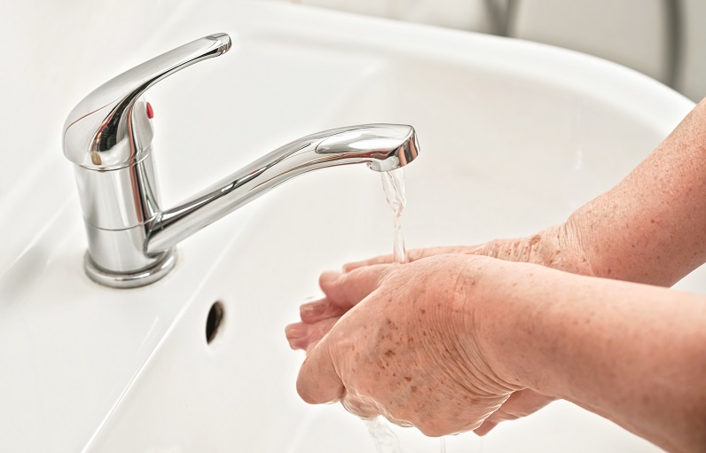 older adult cleaning hands to prevent covid-19 coronavirus infection from spreading