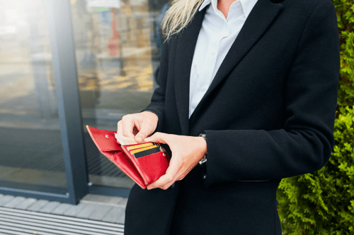 Woman taking cash out of purse