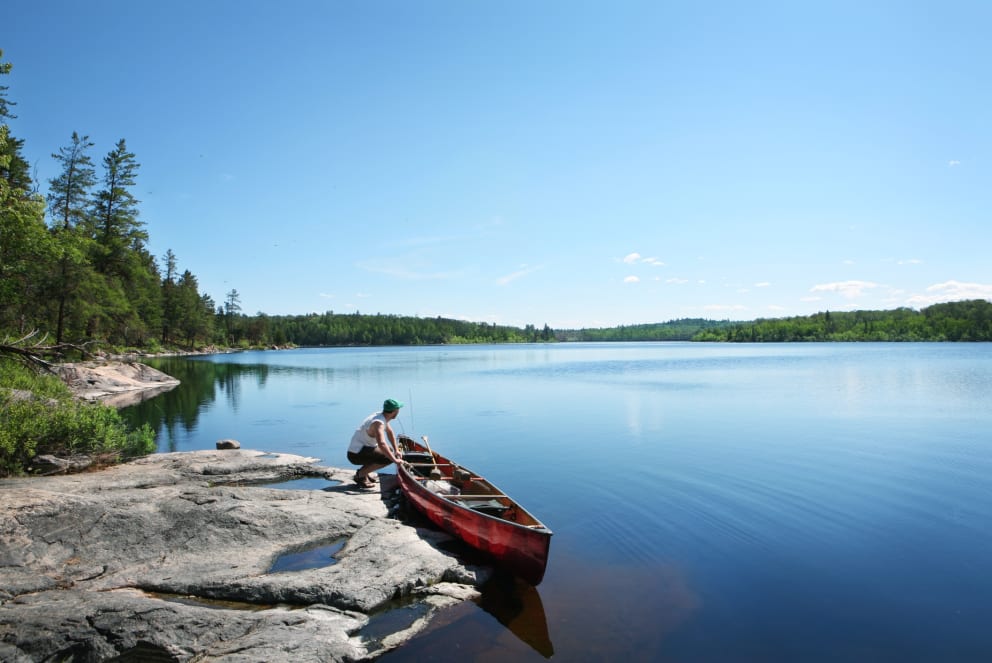 man canoeing in minnesota