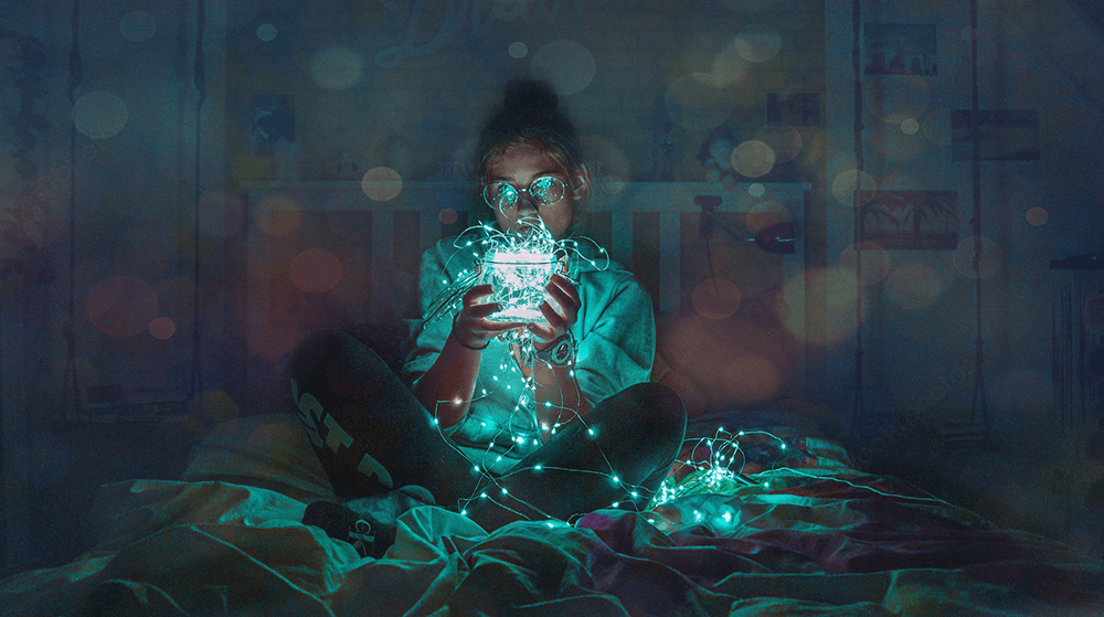 Young girl playing with string lights