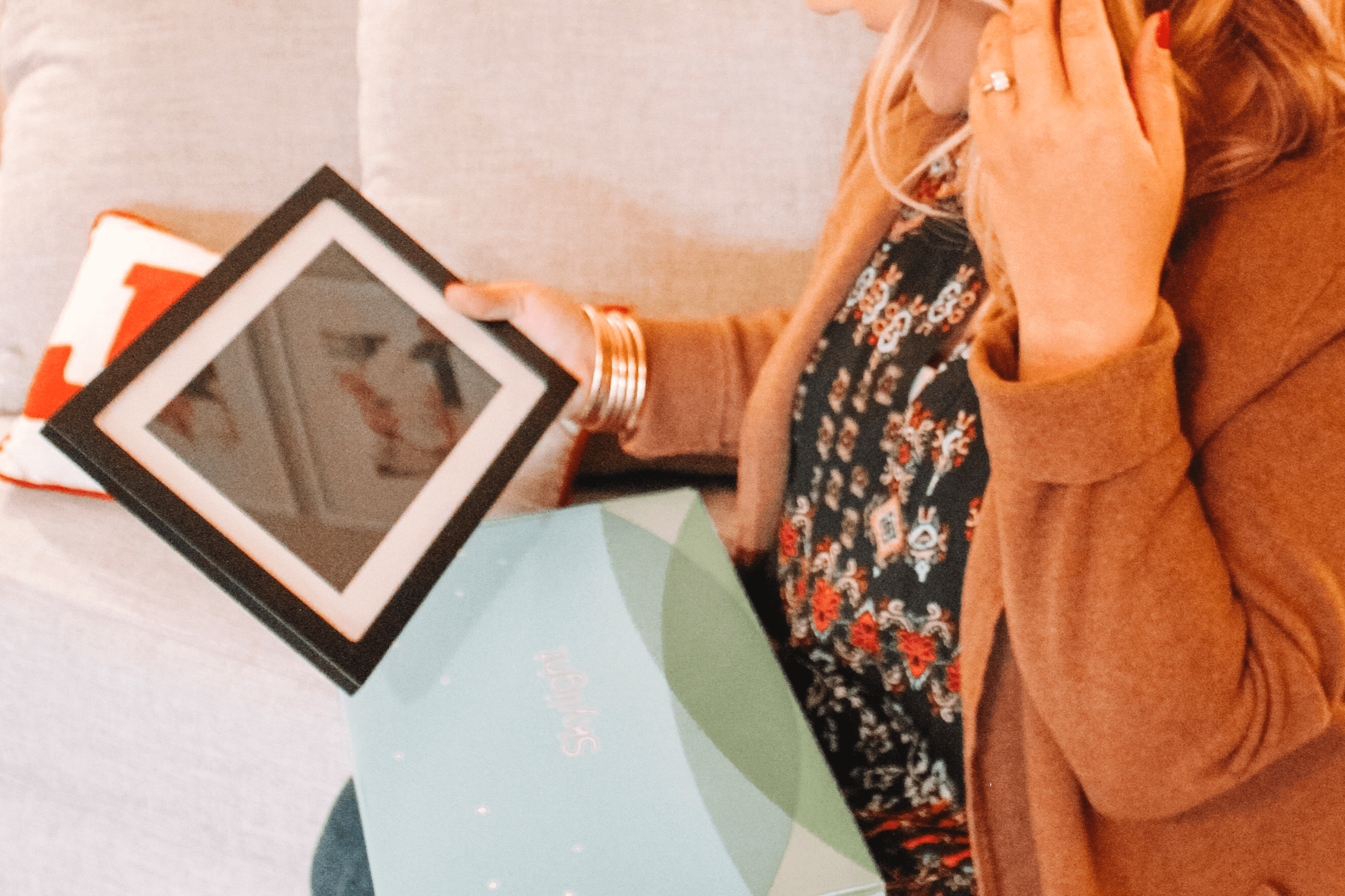 Mom opening digital photo frame gift