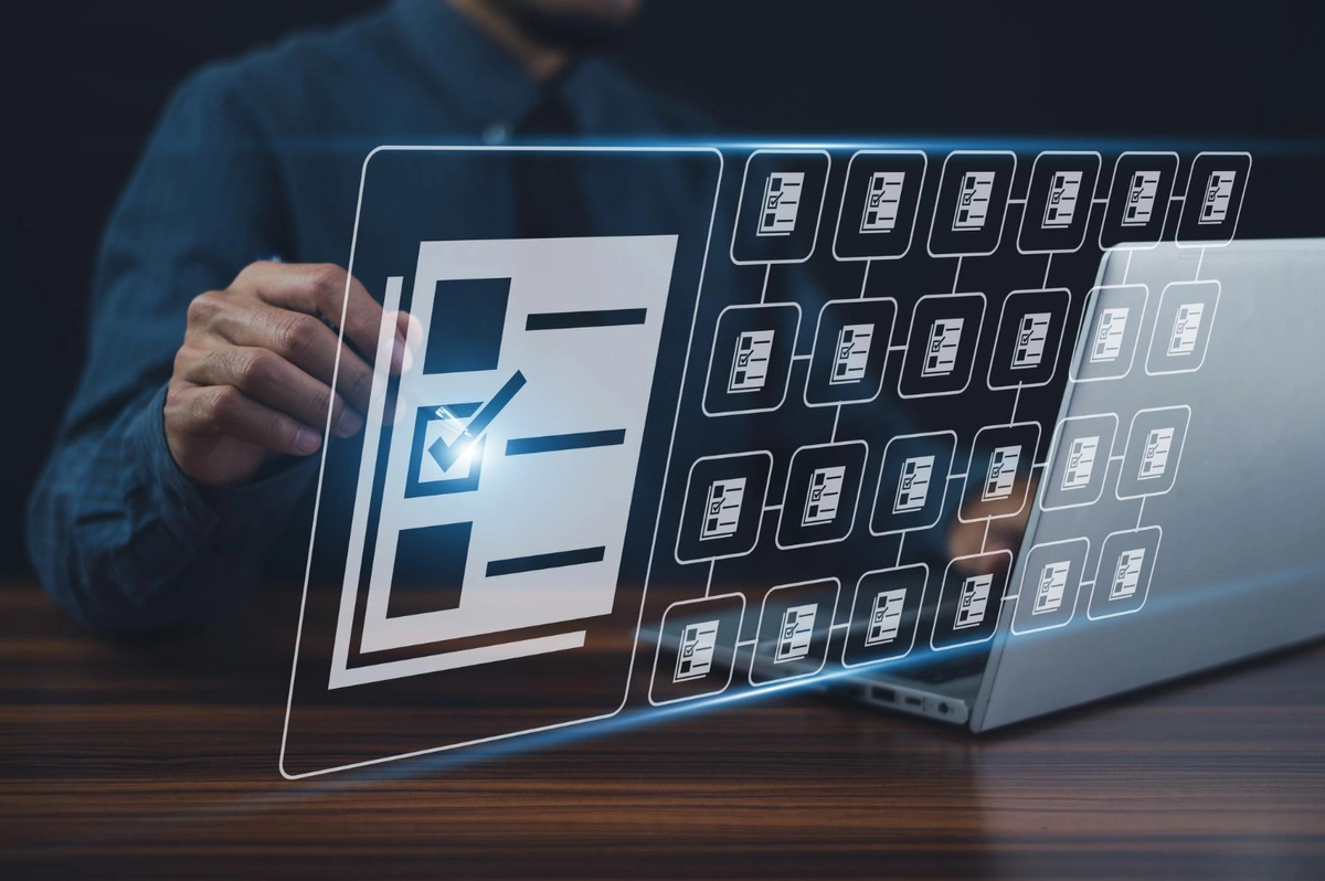  A user is working on a laptop with a virtual interface that projects from the screen, showing a file system organization concept with folders and a check mark on one of them, symbolizing file management or data organization.