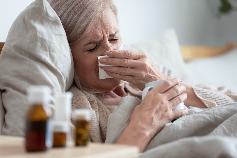 Elderly woman coughing - Adults 65 - older - risk severe illness - death from COVID-19 - coronavirus