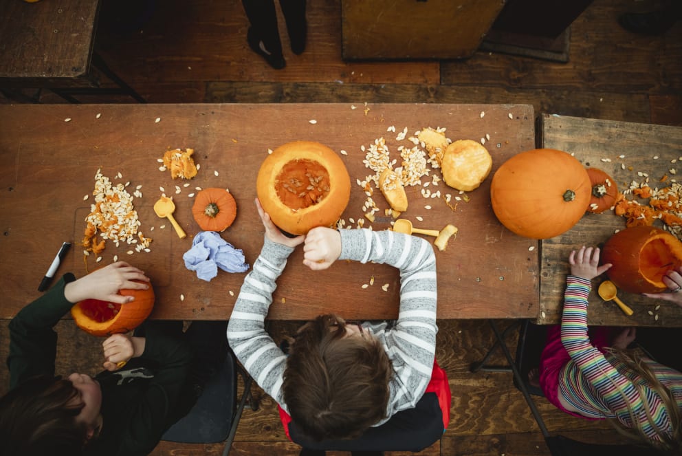 kids carving pumpkins at halloween